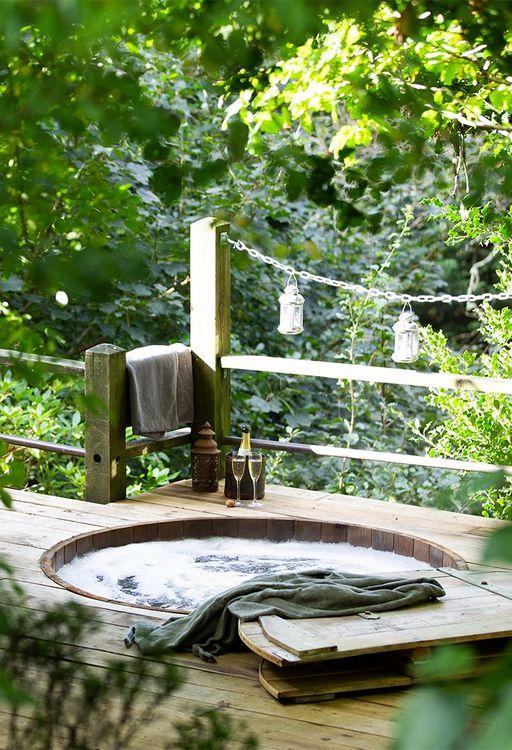 Hot tub built into decking with fairy lights 