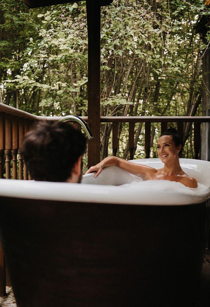 A couple enjoying an outdoor bath together 