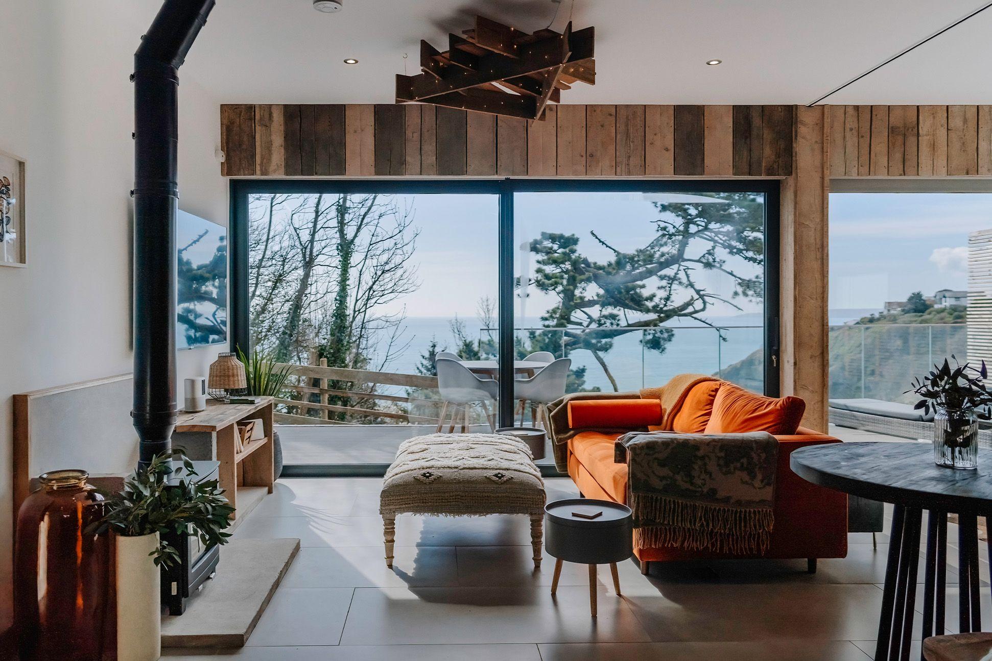 Interior of a cabin with sofa and log burner