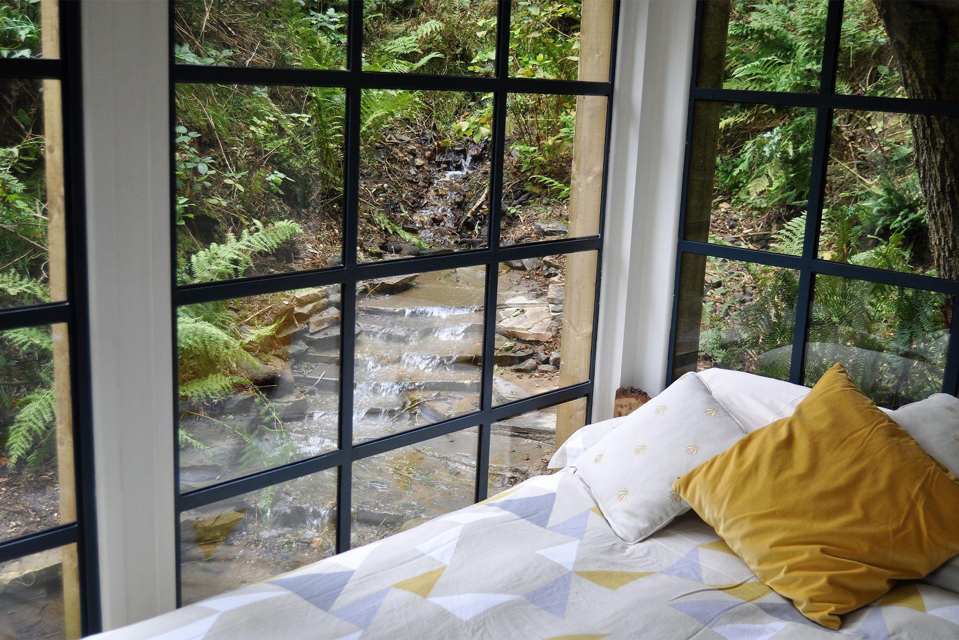 View out of a cabin over a waterfall