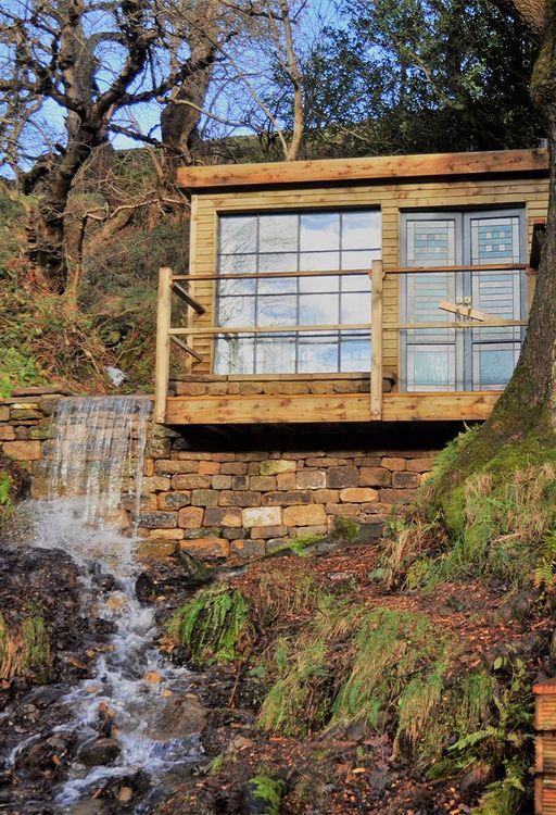 Cabin next to a waterfall