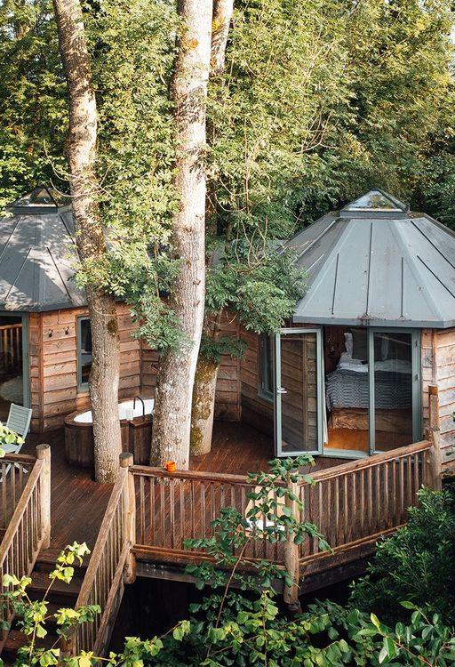 Drone view of a treehouse with a bath on the deck