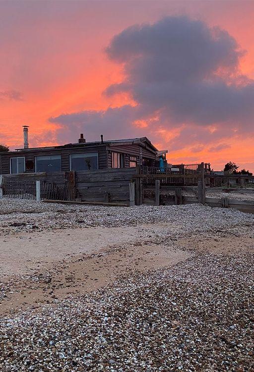 Cabin on the beach at sunset