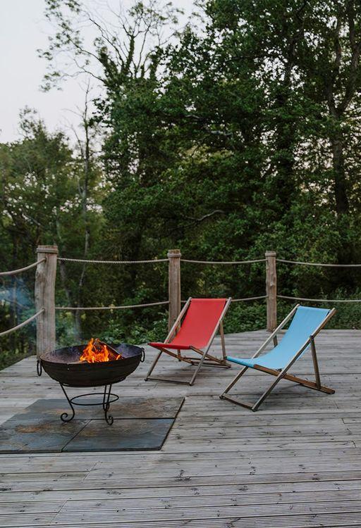 Deck of a treehouse with a firepit