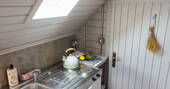 Kitchen equipped with a hob, fridge, microwave and all cooking utensils