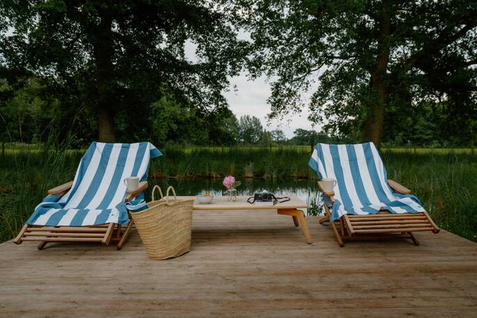 Deck chairs by the swimming pond