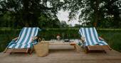 Deck chairs by the swimming pond