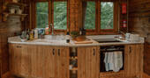 Kitchen equipped with an oven, induction hob, crockery, glassware and cooking utensils