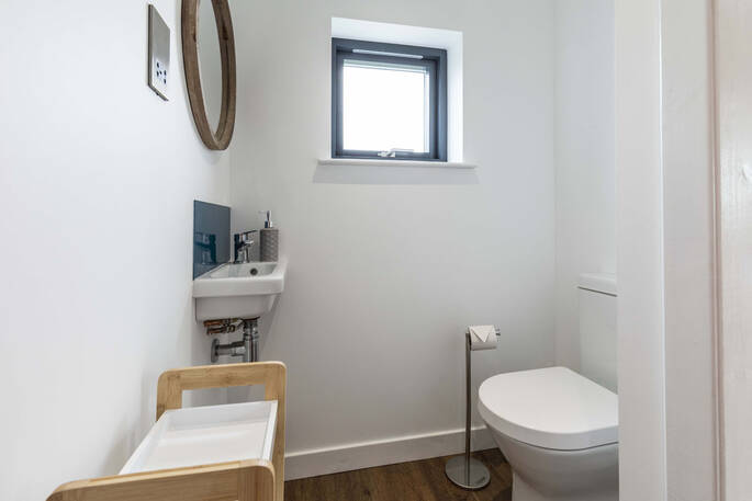 Bathroom with a shower, flushing toilet and sink