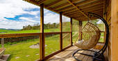 Swing on the deck with a view to the garden