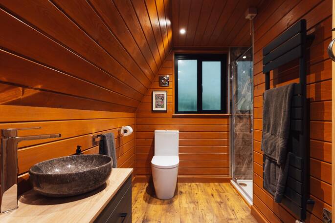 Large bathroom with a shower, sink and flushing toilet