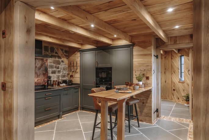 Open plan kitchen equipped with an oven, stove, and full fridge