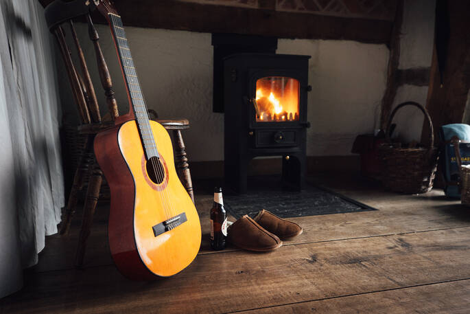 The Sleepout fireplace and guitar