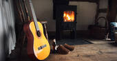 The Sleepout fireplace and guitar
